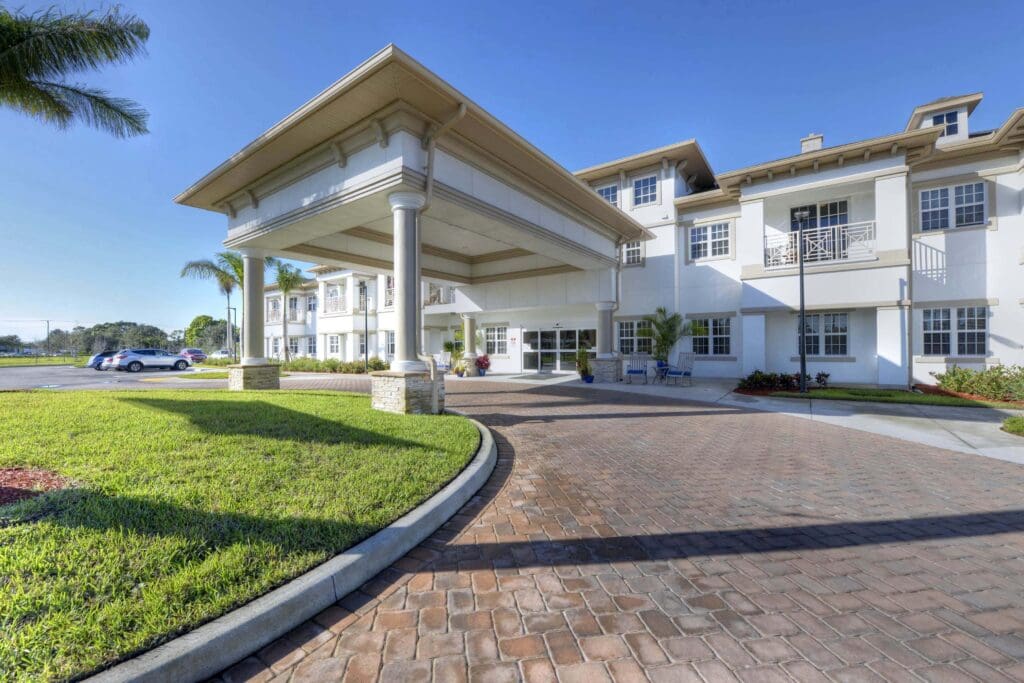 Beach House senior living community front drive leading to the white building.